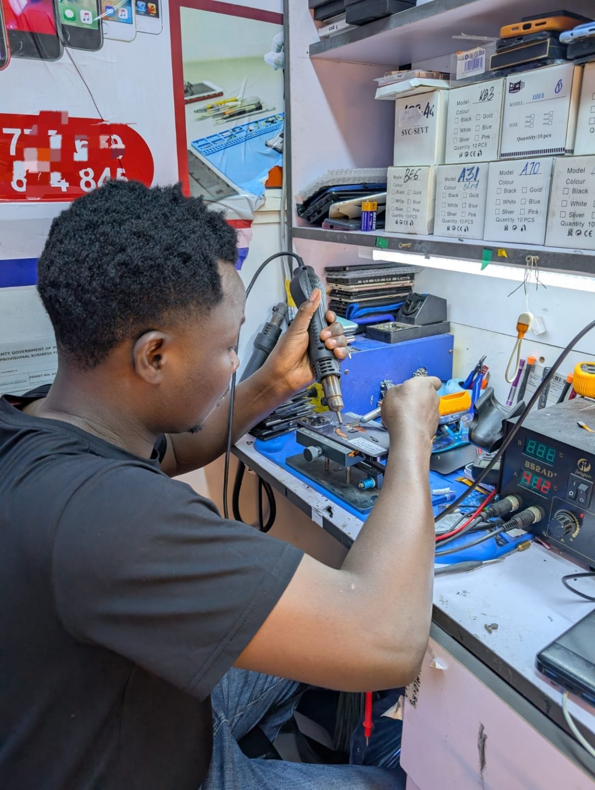 Phone repair technician working at Saeed Phone Repair and Services